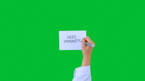 Doctor-Writing-Herd-Immunity-on-Paper-with-Green-Screen